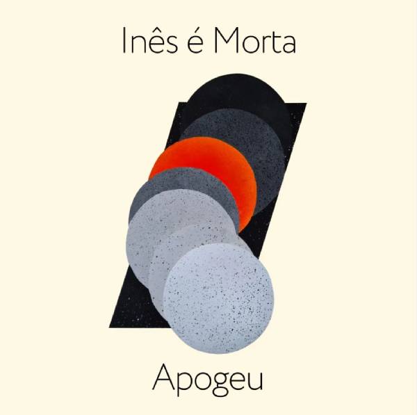 Capa do single "Apogeu", da banda Inês é Morta, mostra vários círculos em escala de cinza com apenas um em cor laranja ao centro em um fundo creme, quase branco, parecendo planetas alinhados